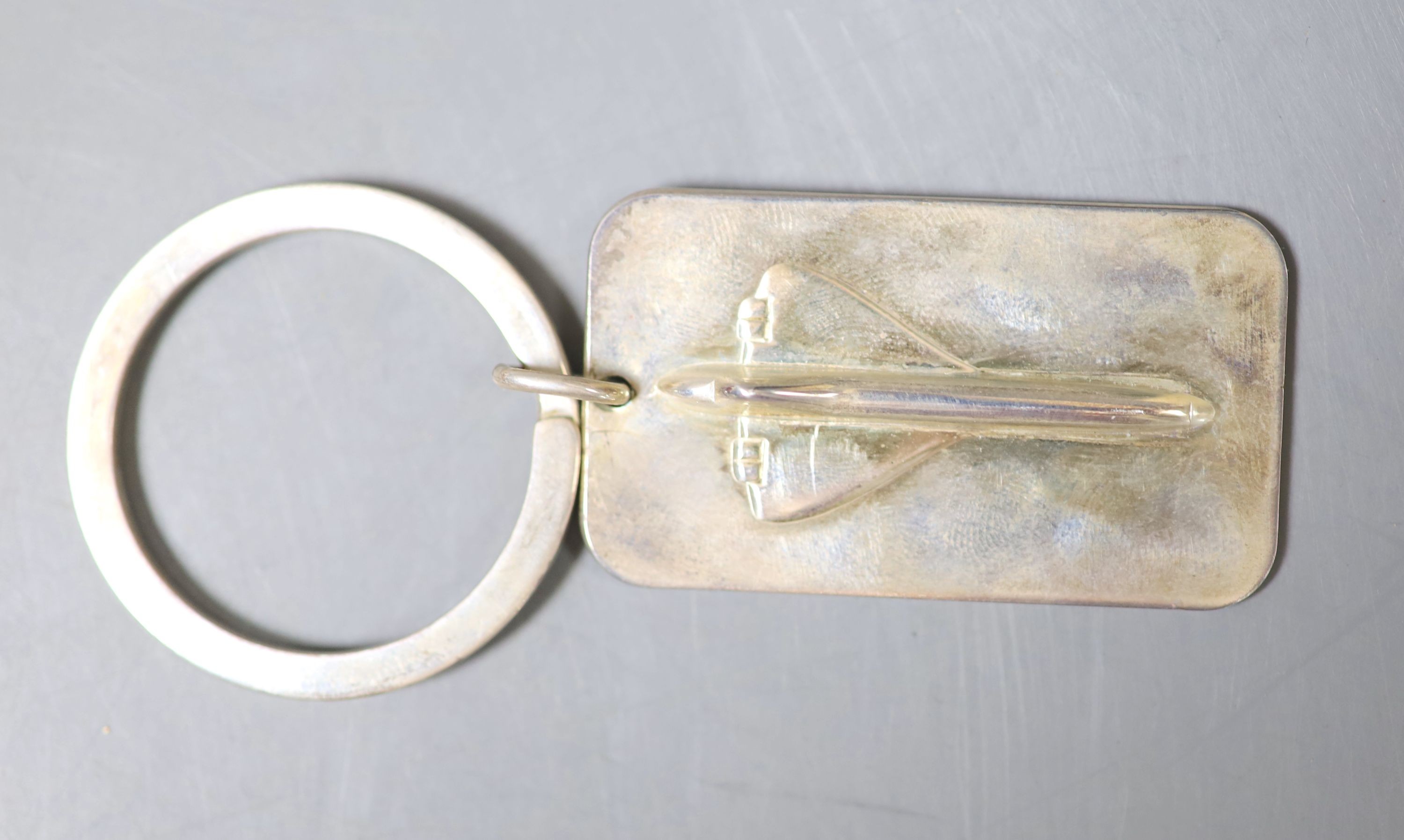 A modern Links of London, Concorde commemorative key ring, the ring only with silver hallmark, overall 83mm, in Links of London box, together with four silver napkin rings, a silver compact and a silver mounted glass sce